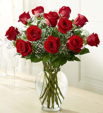 dozen red roses in glass vase